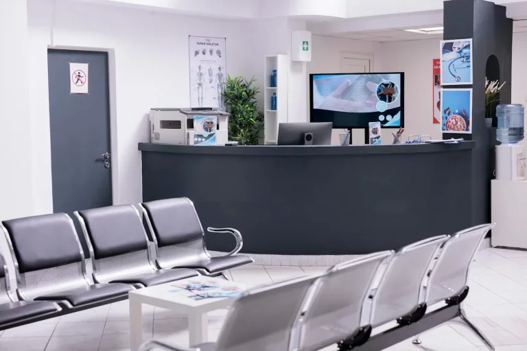 clinical-reception-with-waiting-room-facility-lobby-registration-counter-used-patients-with-medical-appointments-empty-reception-desk-health-center-checkup-visits_482257-51247